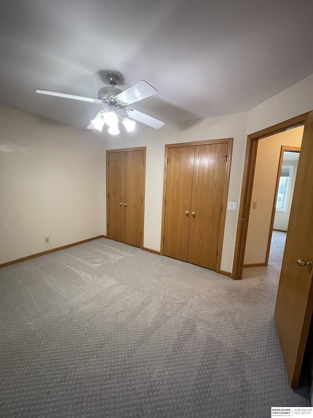 13406 Erskine St, Omaha, NE 68164 - unfurnished bedroom featuring light carpet, multiple closets, and a ceiling fan
