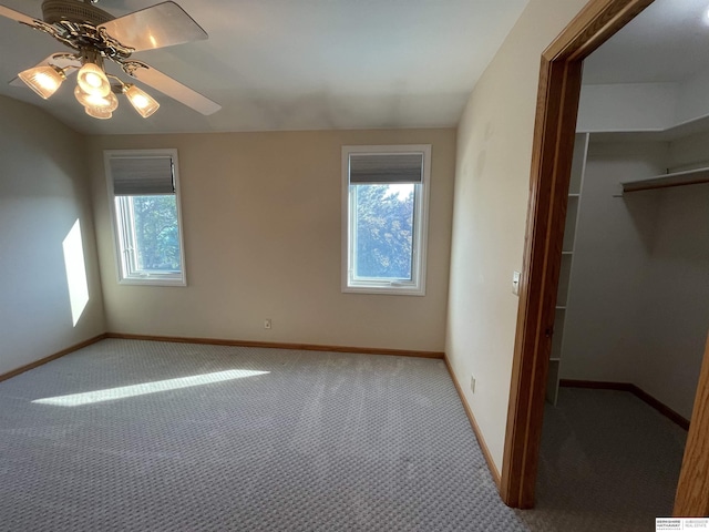 13406 Erskine St, Omaha, NE 68164 - unfurnished bedroom featuring a walk in closet, carpet, a closet, and ceiling fan