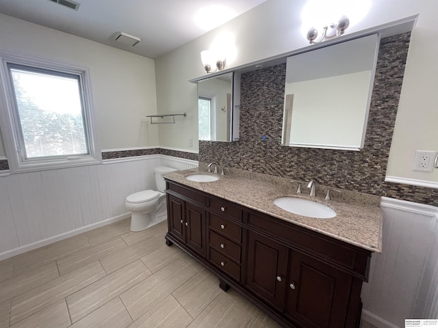 13406 Erskine St, Omaha, NE 68164 - bathroom featuring healthy amount of natural light, double vanity, and a wainscoted wall