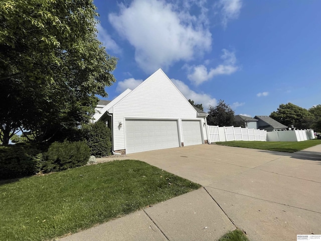 13406 Erskine St, Omaha, NE 68164 - view of property exterior featuring an attached garage and concrete driveway