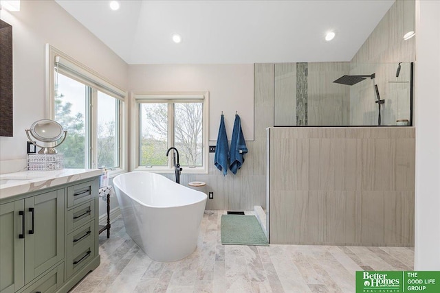 5850 Country Squire Plz, Omaha, NE 68152 - bathroom with a walk in shower, a freestanding tub, vanity, tile walls, and recessed lighting