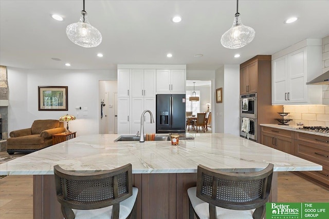 5850 Country Squire Plz, Omaha, NE 68152 - kitchen with appliances with stainless steel finishes, backsplash, light wood-style floors, a large island, and recessed lighting