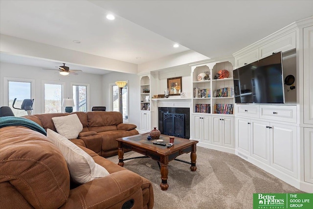 5850 Country Squire Plz, Omaha, NE 68152 - living area with light colored carpet, a ceiling fan, a glass covered fireplace, and recessed lighting