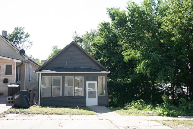 1204 S 27th St, Omaha, NE 68105 - view of front of house featuring a sunroom and roof with shingles