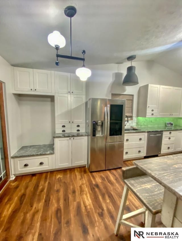 19003 Morrissey Cir, Omaha, NE 68022 - kitchen featuring stainless steel appliances, light stone counters, dark wood-style flooring, white cabinets, and lofted ceiling