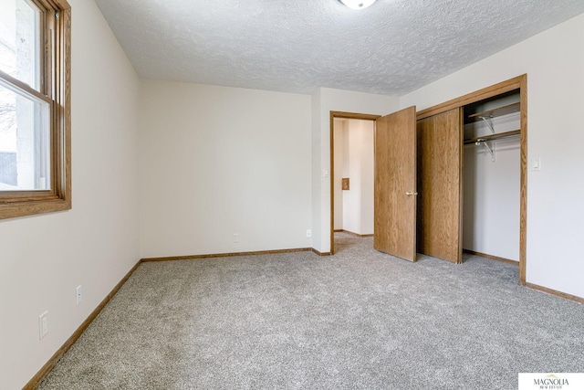 5424 Canterbury Ln Unit 5424, Lincoln, NE 68512 - unfurnished bedroom with light carpet, a closet, and a textured ceiling