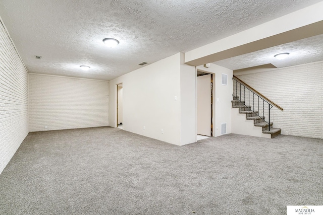 5424 Canterbury Ln Unit 5424, Lincoln, NE 68512 - finished basement with brick wall, a textured ceiling, stairway, and carpet
