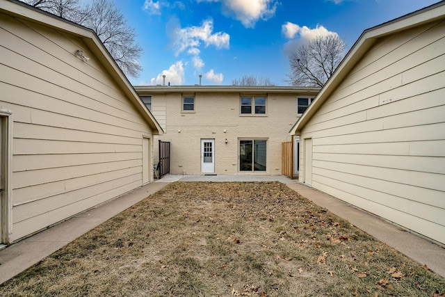 5424 Canterbury Ln Unit 5424, Lincoln, NE 68512 - back of property with brick siding and a patio area