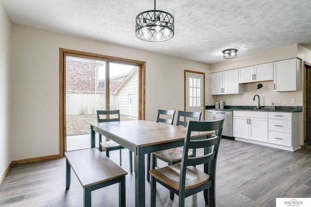 5424 Canterbury Ln Unit 5424, Lincoln, NE 68512 - dining space featuring wood finished floors, a textured ceiling, and a chandelier