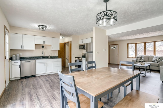 5424 Canterbury Ln Unit 5424, Lincoln, NE 68512 - dining space featuring a textured ceiling and light wood finished floors
