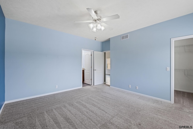 6736 S 191st St, Omaha, NE 68135 - unfurnished bedroom with a walk in closet, carpet flooring, a closet, and ceiling fan