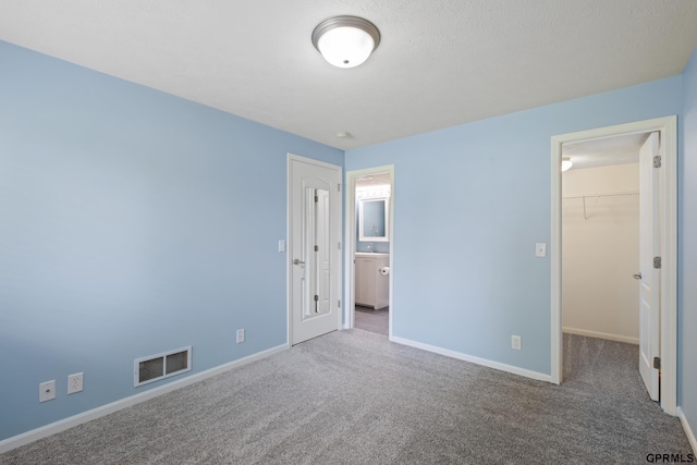 6736 S 191st St, Omaha, NE 68135 - unfurnished bedroom with a walk in closet, carpet, a closet, and ensuite bathroom