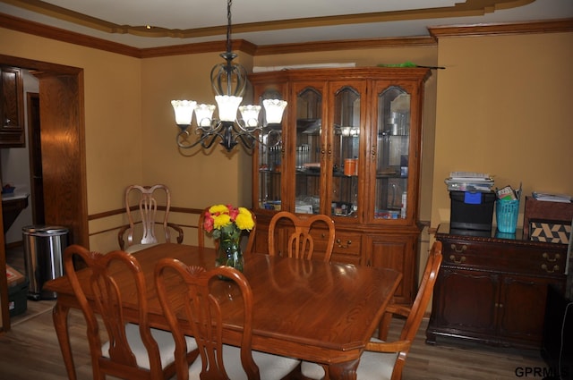 1017 N 129th Cir, Omaha, NE 68154 - dining area featuring wood finished floors, a chandelier, and crown molding