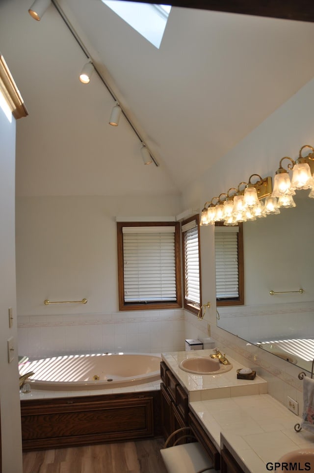 1017 N 129th Cir, Omaha, NE 68154 - full bath featuring lofted ceiling, a whirlpool tub, wood finished floors, vanity, and track lighting