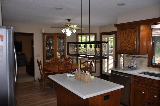 1017 N 129th Cir, Omaha, NE 68154 - kitchen featuring stainless steel appliances, dark wood-style floors, tasteful backsplash, light countertops, and a ceiling fan