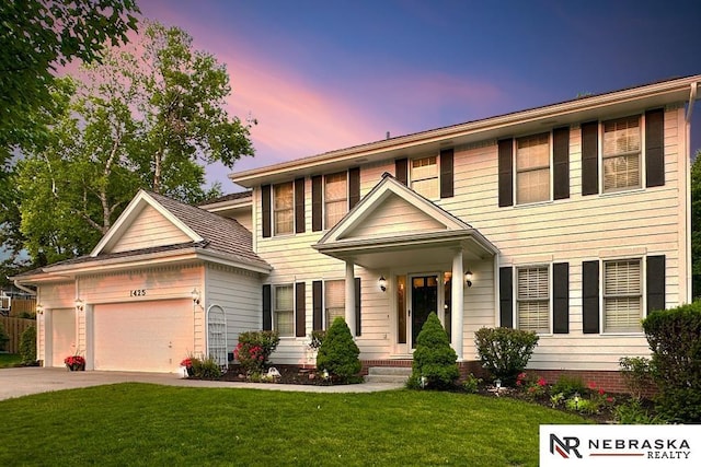 1425 S 158th Cir, Omaha, NE 68130 - colonial house featuring an attached garage, a front lawn, and concrete driveway
