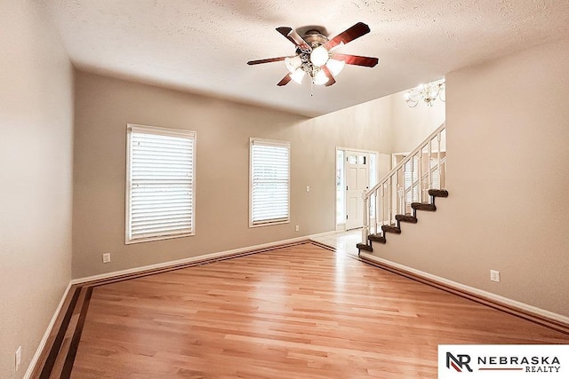 1425 S 158th Cir, Omaha, NE 68130 - foyer with ceiling fan, light wood-style floors, stairway, and a textured ceiling