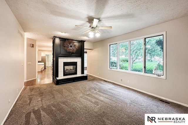 1425 S 158th Cir, Omaha, NE 68130 - unfurnished living room with a ceiling fan, carpet flooring, a fireplace, and a textured ceiling