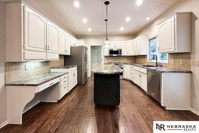 1425 S 158th Cir, Omaha, NE 68130 - kitchen with stainless steel appliances, a center island, dark wood-style flooring, dark stone countertops, and recessed lighting