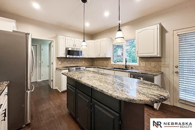 1425 S 158th Cir, Omaha, NE 68130 - kitchen with stainless steel appliances, white cabinets, dark cabinetry, dark wood-type flooring, and recessed lighting