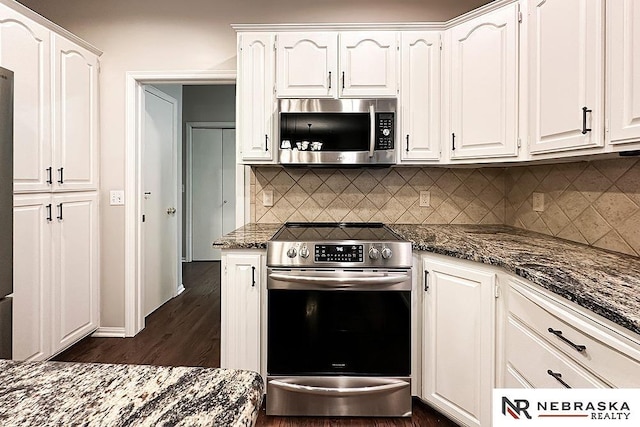 1425 S 158th Cir, Omaha, NE 68130 - kitchen featuring stainless steel appliances, white cabinets, backsplash, and dark stone counters