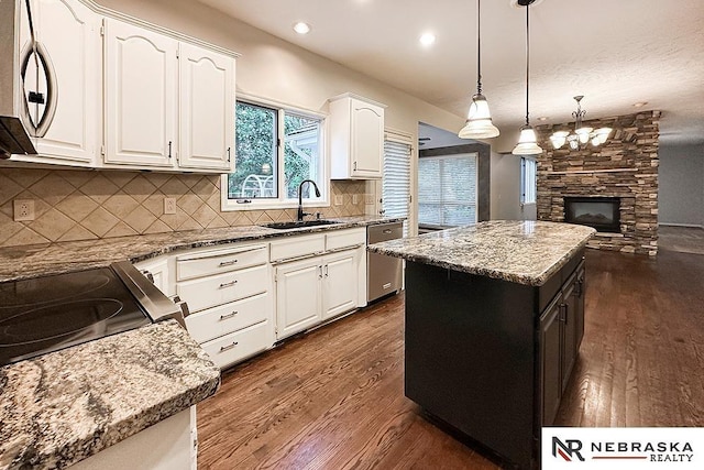 1425 S 158th Cir, Omaha, NE 68130 - kitchen featuring appliances with stainless steel finishes, dark wood finished floors, light stone countertops, and recessed lighting