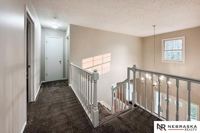1425 S 158th Cir, Omaha, NE 68130 - hallway featuring an upstairs landing, a textured ceiling, and carpet floors