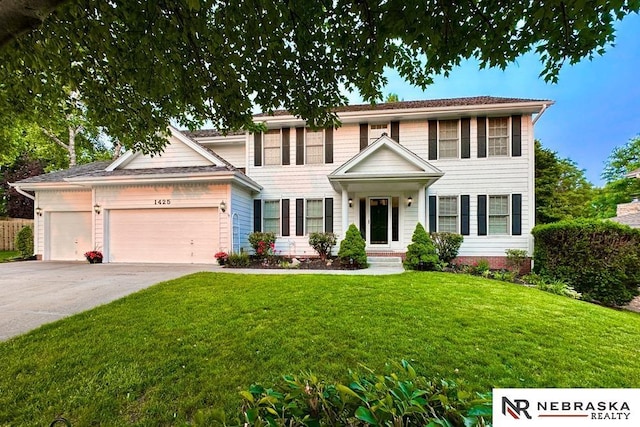 1425 S 158th Cir, Omaha, NE 68130 - colonial home featuring an attached garage, concrete driveway, and a front yard