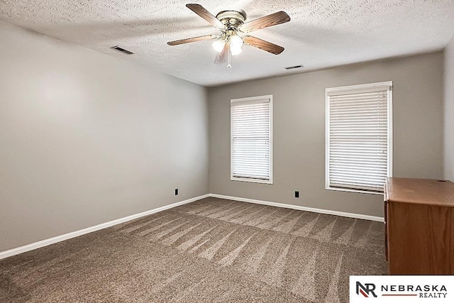1425 S 158th Cir, Omaha, NE 68130 - empty room with dark colored carpet, a textured ceiling, and ceiling fan