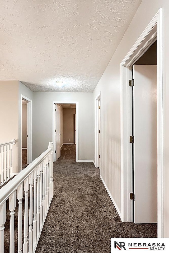 1425 S 158th Cir, Omaha, NE 68130 - hall with dark carpet, an upstairs landing, and a textured ceiling