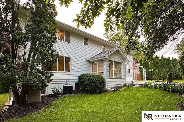 1425 S 158th Cir, Omaha, NE 68130 - back of house featuring a lawn and a sunroom