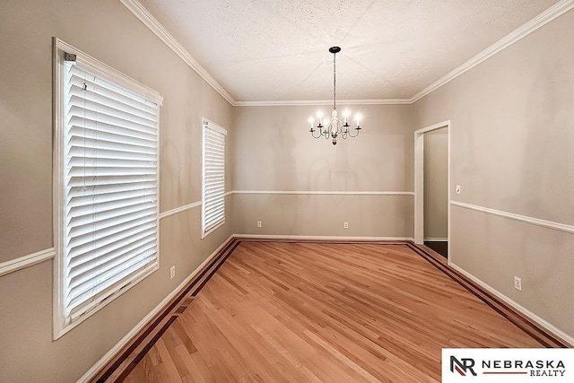 1425 S 158th Cir, Omaha, NE 68130 - unfurnished dining area featuring light wood-style floors, a chandelier, and ornamental molding