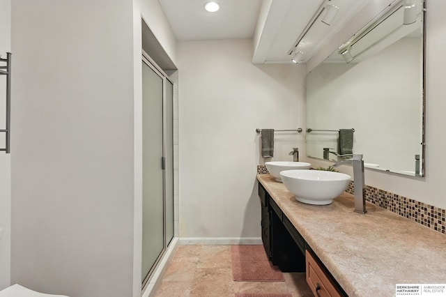 7504 S 46th Ave, Omaha, NE 68157 - full bathroom with a stall shower, double vanity, tasteful backsplash, and recessed lighting