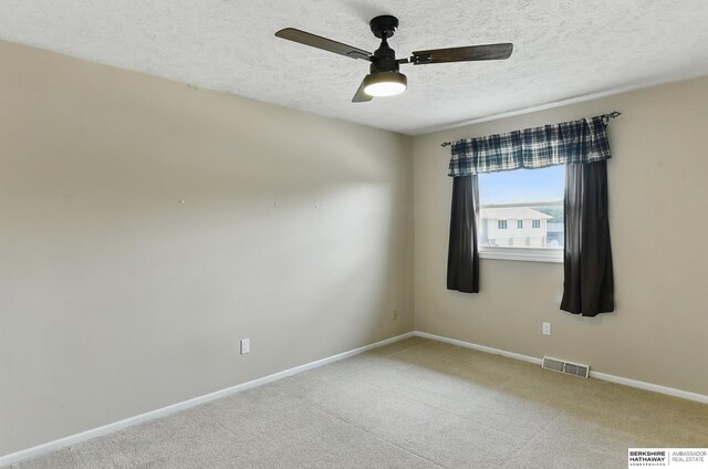 7504 S 46th Ave, Omaha, NE 68157 - spare room featuring a textured ceiling, carpet flooring, and ceiling fan