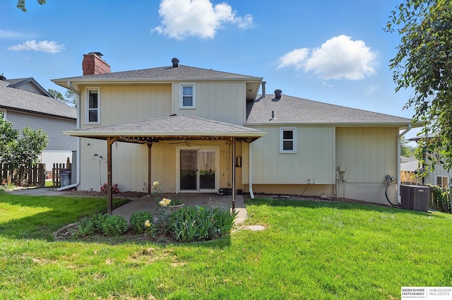 7504 S 46th Ave, Omaha, NE 68157 - back of property with a patio area, a chimney, and a lawn