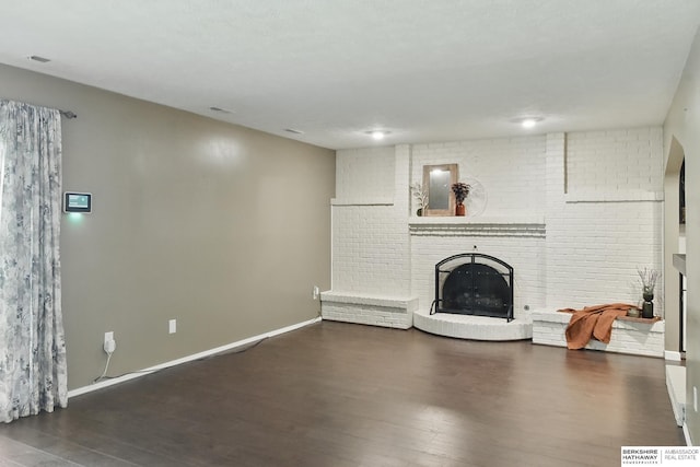 7504 S 46th Ave, Omaha, NE 68157 - unfurnished living room featuring wood finished floors and a brick fireplace