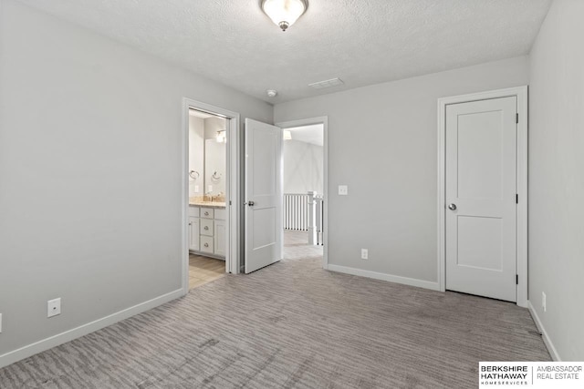 19014 Pratt Cir, Elkhorn, NE 68022 - unfurnished bedroom with light colored carpet, a textured ceiling, and ensuite bath