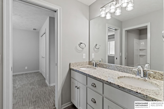 19014 Pratt Cir, Elkhorn, NE 68022 - bathroom featuring double vanity and a textured ceiling
