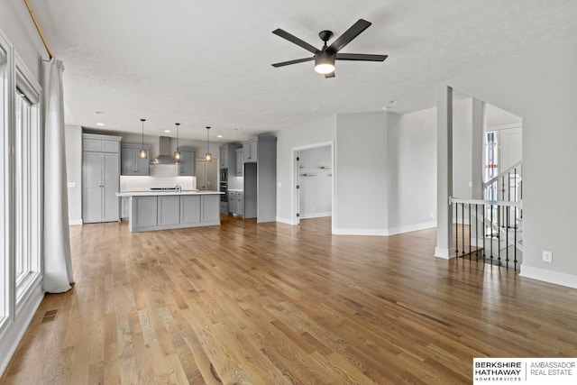 19014 Pratt Cir, Elkhorn, NE 68022 - unfurnished living room with light wood-style flooring, ceiling fan, and recessed lighting