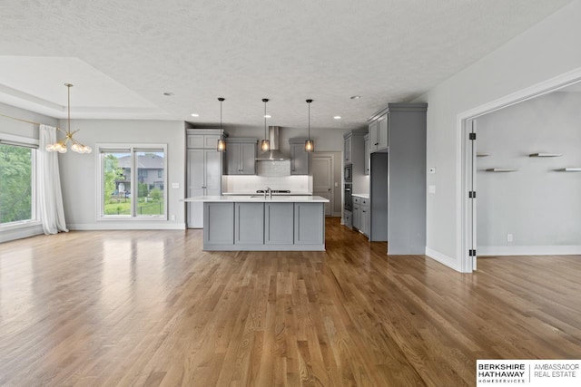 19014 Pratt Cir, Elkhorn, NE 68022 - kitchen with gray cabinets, a chandelier, light countertops, light wood finished floors, and recessed lighting