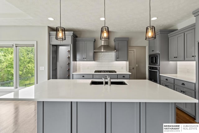 19014 Pratt Cir, Elkhorn, NE 68022 - kitchen featuring gray cabinetry, appliances with stainless steel finishes, tasteful backsplash, light countertops, and recessed lighting