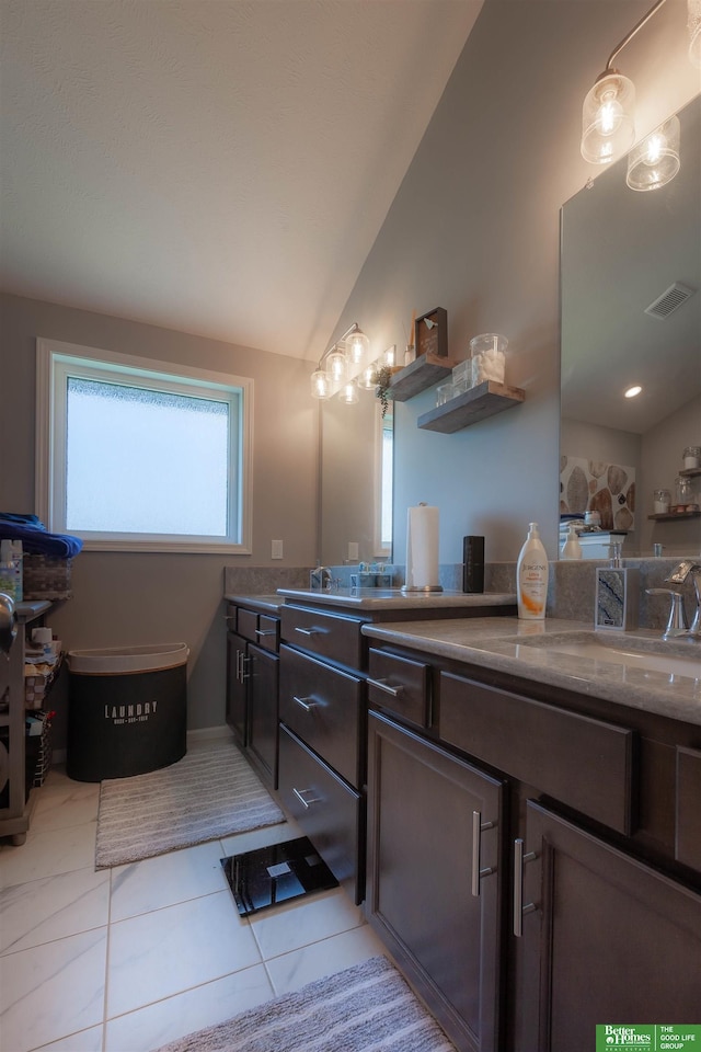 12210 Quail Dr, Bellevue, NE 68123 - bathroom featuring lofted ceiling, vanity, and tile patterned flooring