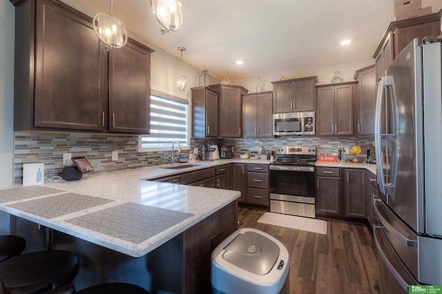 12210 Quail Dr, Bellevue, NE 68123 - kitchen featuring appliances with stainless steel finishes, a peninsula, dark wood-style flooring, dark brown cabinets, and tasteful backsplash