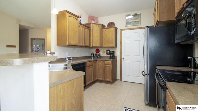 1933 Redstone Rd, Lincoln, NE 68521 - kitchen featuring black appliances, light tile patterned floors, brown cabinetry, a peninsula, and light countertops