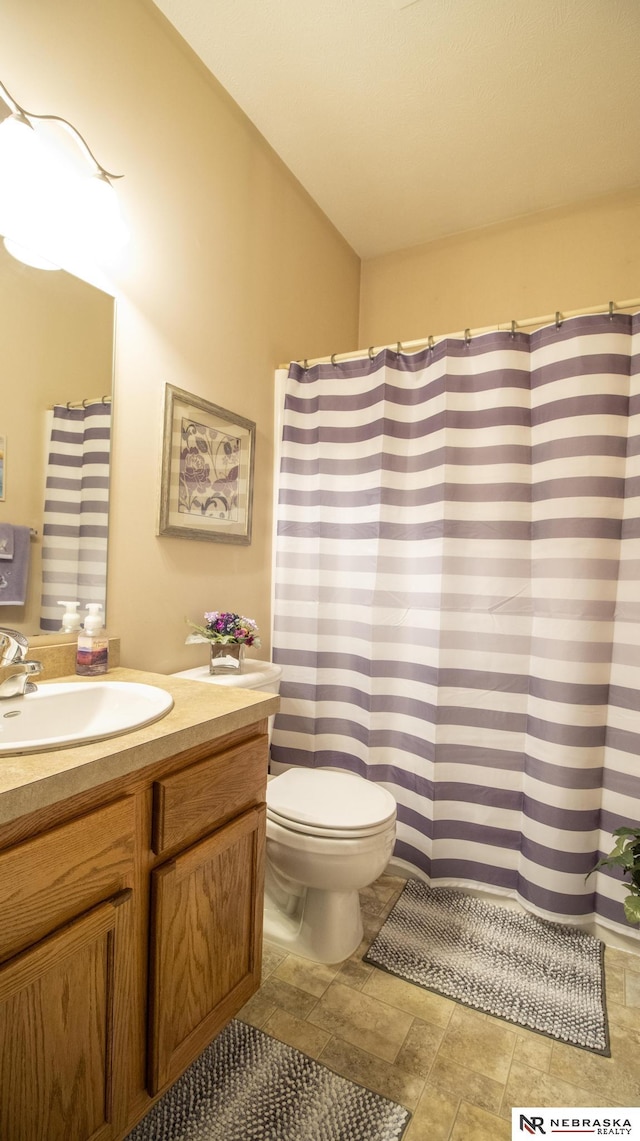 1933 Redstone Rd, Lincoln, NE 68521 - bathroom featuring vanity, stone finish flooring, and curtained shower