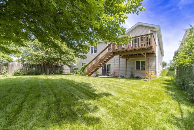 1933 Redstone Rd, Lincoln, NE 68521 - rear view of house featuring stairway, a fenced backyard, and a wooden deck