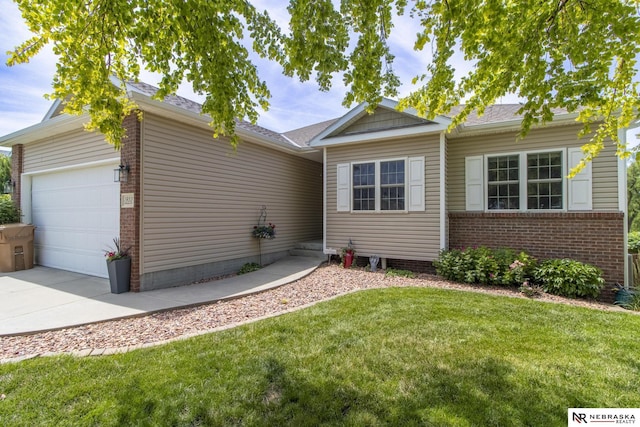 1933 Redstone Rd, Lincoln, NE 68521 - ranch-style house featuring brick siding, a front yard, driveway, and a garage