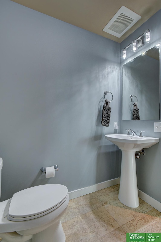 444 Riverfront Plz Unit 501, Omaha, NE 68102 - half bathroom with baseboards and stone tile flooring