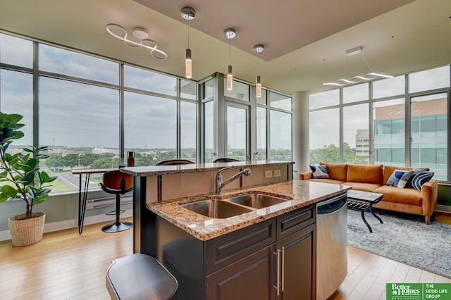 444 Riverfront Plz Unit 501, Omaha, NE 68102 - kitchen featuring light wood-style flooring, a center island with sink, plenty of natural light, and dishwasher