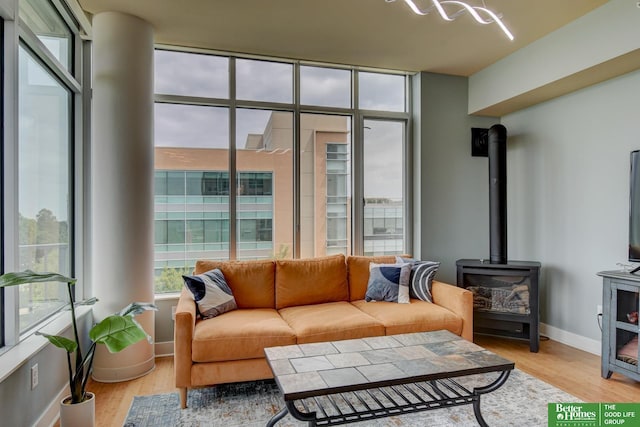 444 Riverfront Plz Unit 501, Omaha, NE 68102 - living room featuring light wood-style flooring and a wood stove